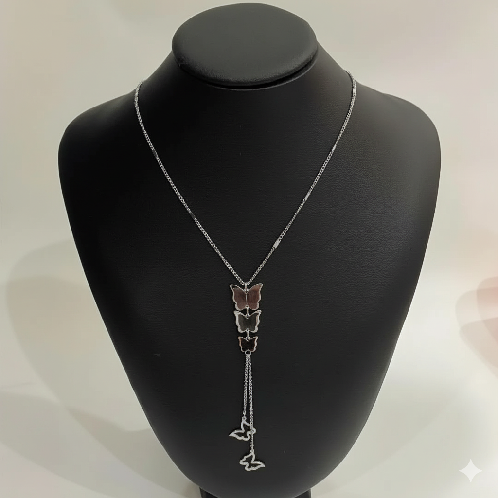Butterfly-themed necklace on a black mannequin bust with a white background