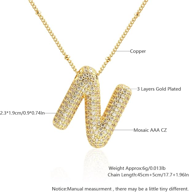 Gold necklace with 'N' pendant featuring technical details on a white background