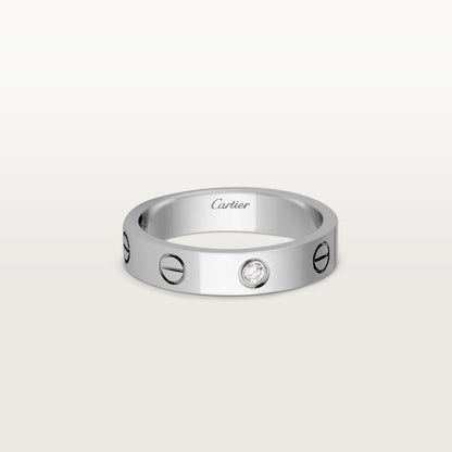 Silver Cartier ring with a diamond on a white background