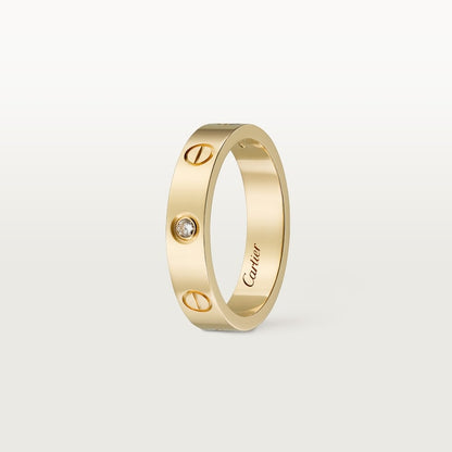 Gold ring with a diamond on a light gray background