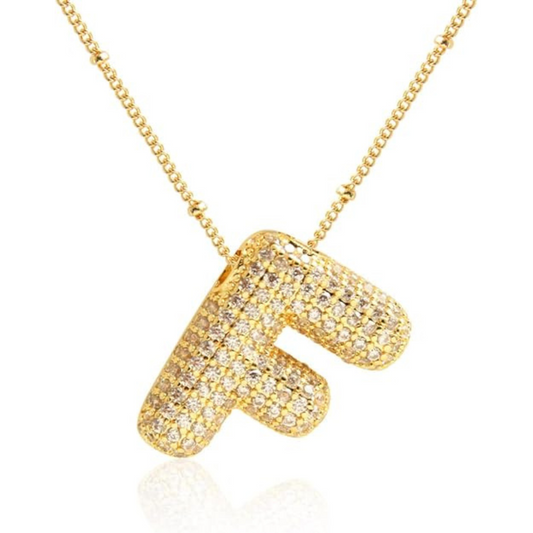 Gold necklace with a letter 'F' pendant on a white background