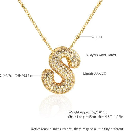 Gold necklace with a letter 'S' pendant on a white background