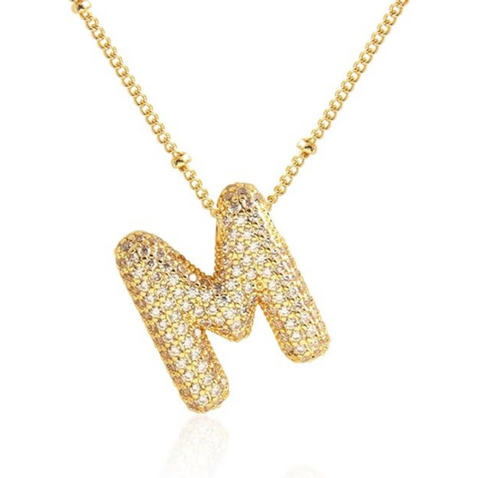 Gold necklace with a unique pendant on a white background