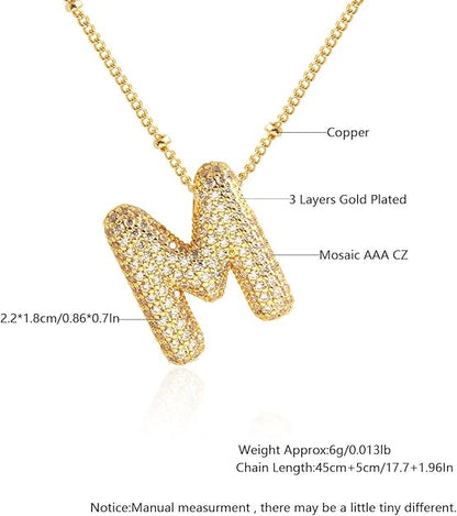 Gold necklace with letter 'M' pendant, showing material details and measurements.