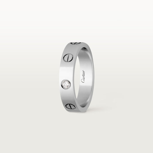 Silver ring with Cartier branding on a white background
