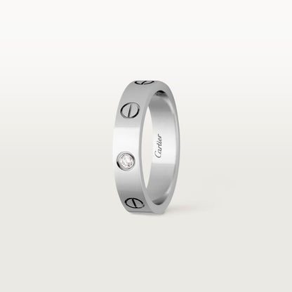 Silver ring with Cartier branding on a white background