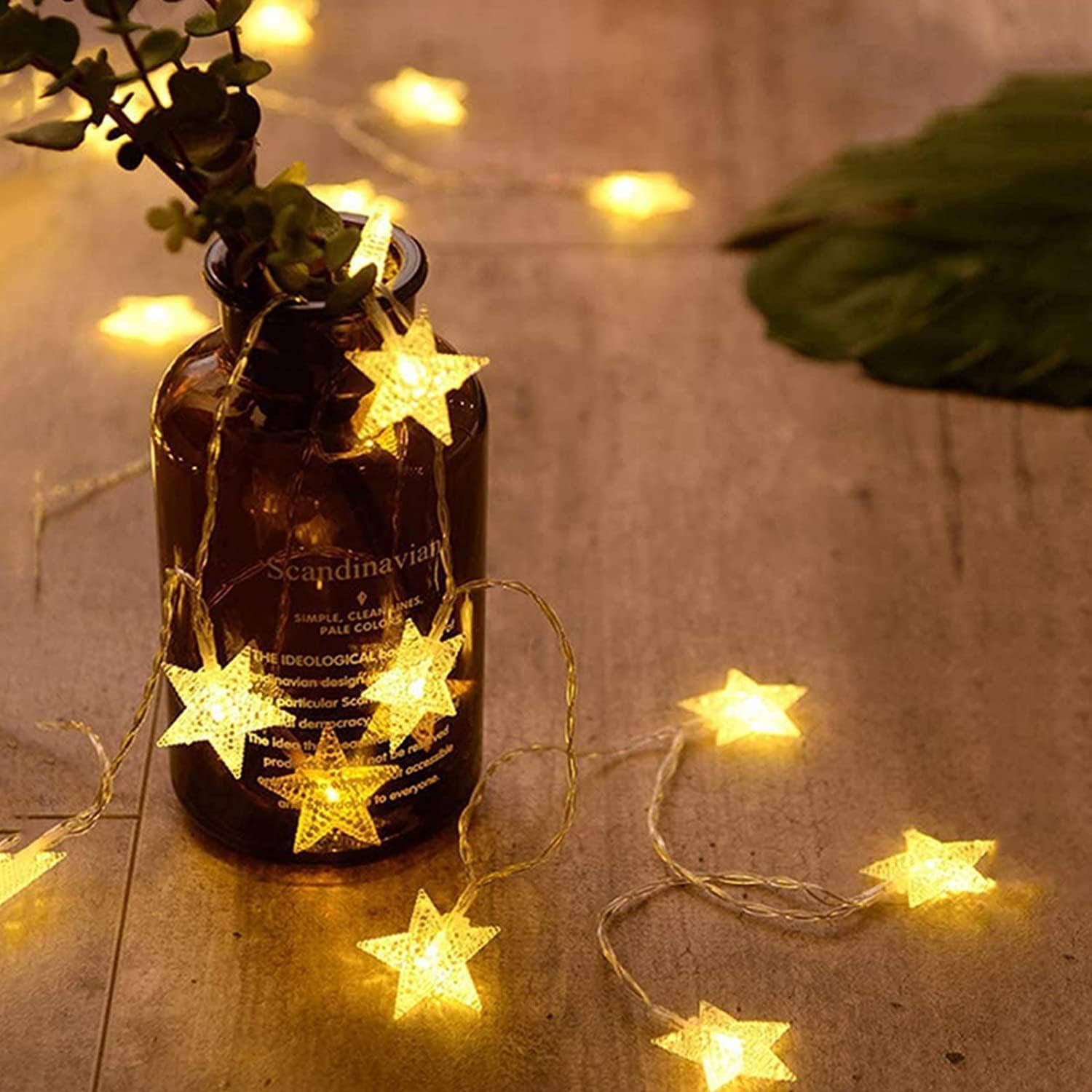 Star-shaped string lights on a bottle with a wooden background
